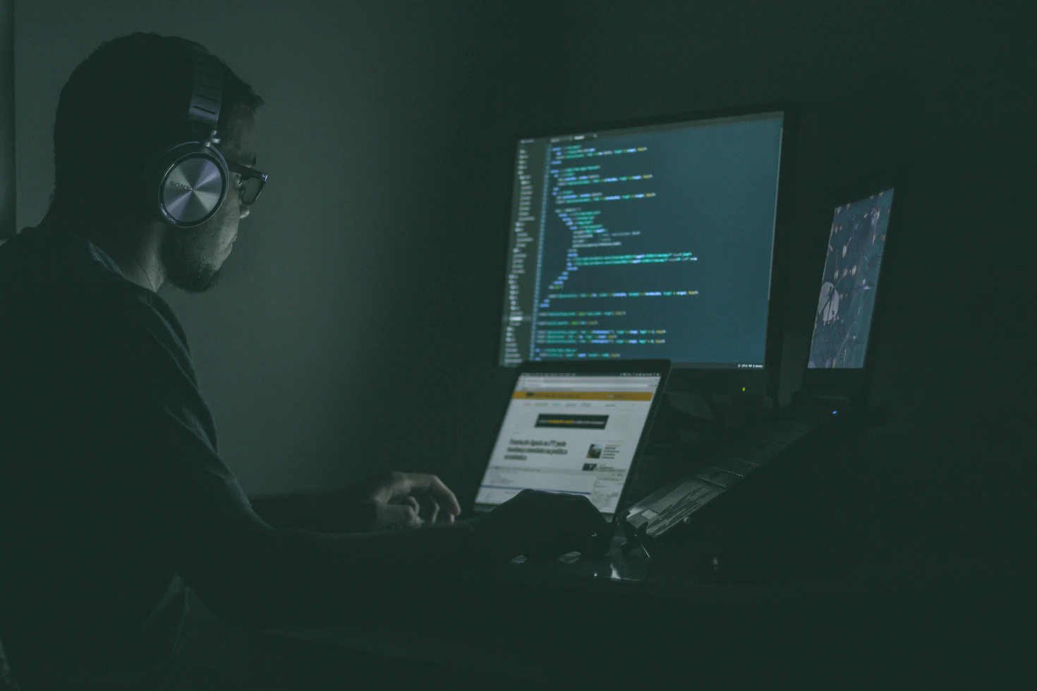 Man sits in front of a computer